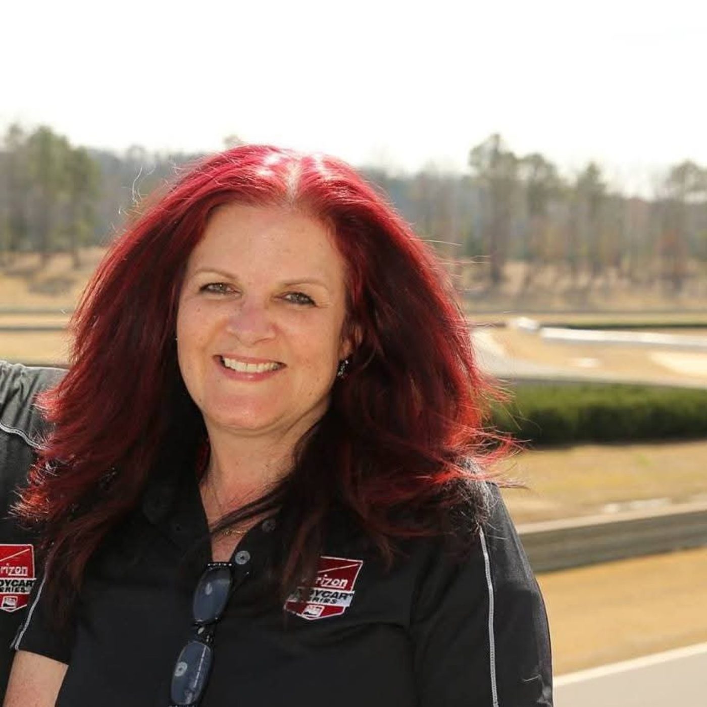 Kathi Pepper trackside in a Verizon IndyCar Series shirt.